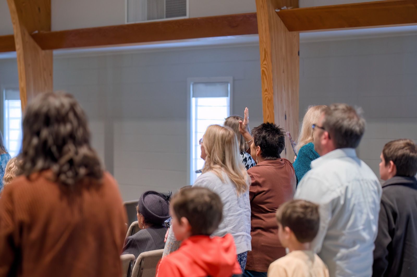 Families standing and singing together during a Sunday worship gathering at Lucy Baptist Church.